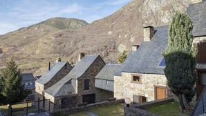 A stone building with a sloped roof, a wooden door, and a window. - Era Cuma by FeelFree Rentals (Pujo)