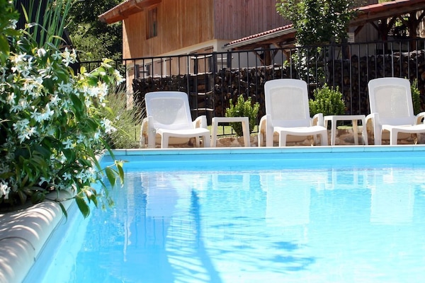 A fenced, child-friendly swimming pool, with wonderful views of the forest ...
