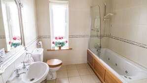 A bathroom with a toilet, sink, and bathtub.