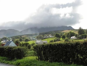A rural landscape with rolling hills, a road, and scattered houses. - The Beach House Apartment (Buncrana)