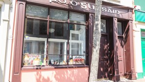 A storefront with large windows displaying various items. - The Merchant's Store (Kilrush)