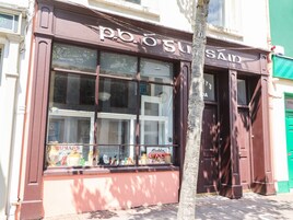 A storefront with large windows displaying various items.