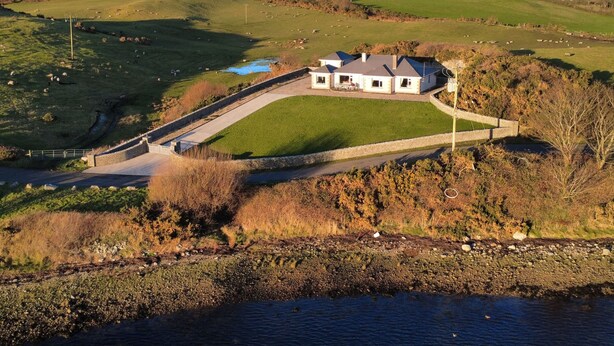 A house with a large lawn, a stone wall, and a view of the surrounding countryside. - Ranny Roe (Maghernalaght)