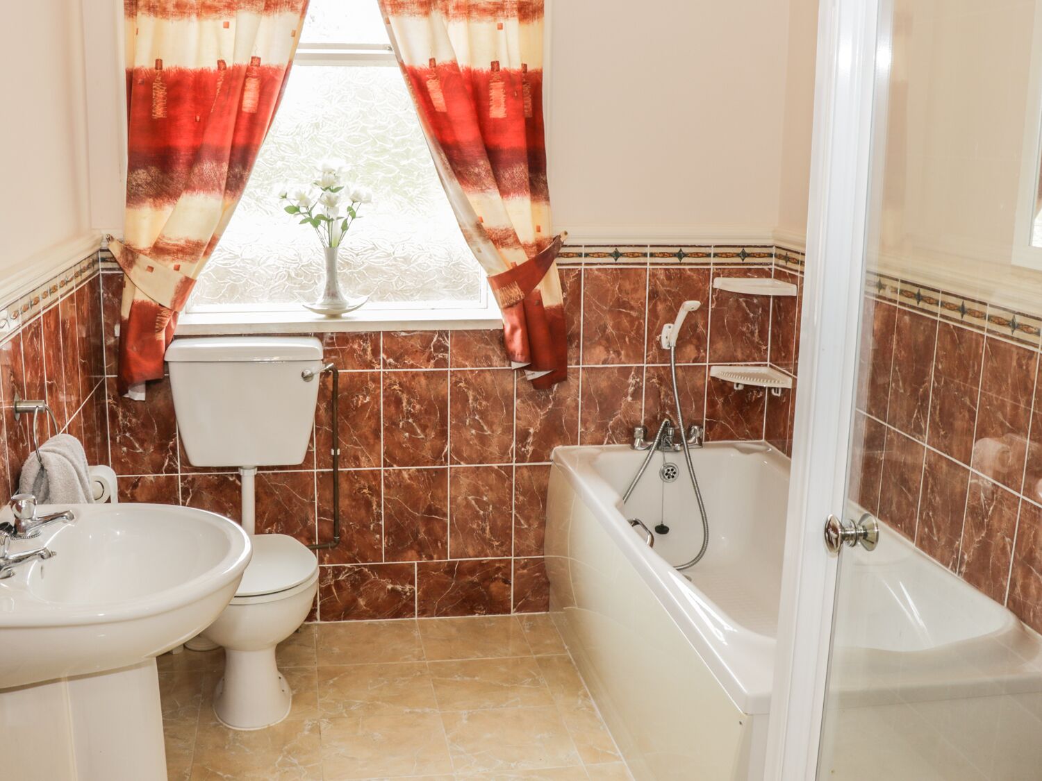 A bathroom with a toilet, sink, and bathtub.