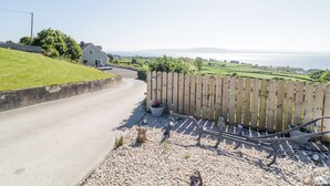 A coastal road leading to a house with a view of the sea. - Tullyally (Moville)