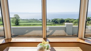 A room with a large window overlooking a scenic landscape. - Tullyally (Moville)