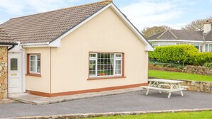 A single-story house with a pitched roof, a front door, and a small window. - Island View (Ardmore)