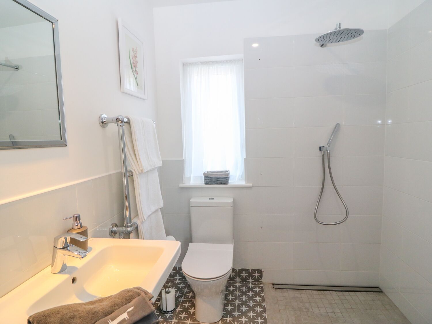 A modern bathroom with a bathtub, toilet, and shower.