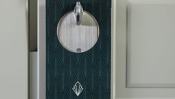 A door with a 'Please Do Not Disturb' sign and a key card holder.