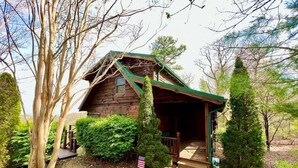 A rustic cabin with a wooden exterior, a porch, and a small deck. - Bear Necessities - Hot tub, View, Spectacular! (Ferguson)