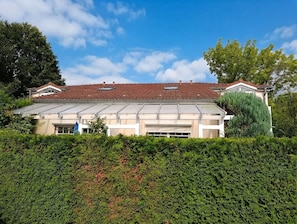 Un bâtiment à deux étages, doté d’un toit plat, de grandes fenêtres et d’un garage.