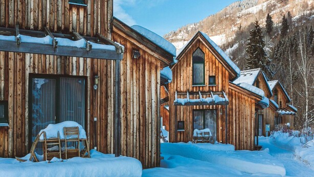 A wooden cabin with a large window and a door, surrounded by snow-covered ground and trees. - Splendid Holiday Home in Kreischberg Murau near Ski Resort (Sankt Georgen am Kreischberg)