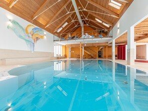 A large indoor swimming pool with a wooden ceiling and a mural on the wall. - Splendid Holiday Home in Kreischberg Murau near Ski Resort (Sankt Georgen am Kreischberg)