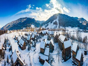 A snow-covered village with wooden cabins and a mountain backdrop. - Splendid Holiday Home in Kreischberg Murau near Ski Resort (Sankt Georgen am Kreischberg)