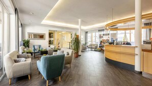 A spacious lobby with a reception desk, seating area, and large windows. - Splendid Holiday Home in Kreischberg Murau near Ski Resort (Sankt Georgen am Kreischberg)