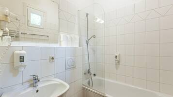 A modern bathroom with a sink, toilet, and shower.