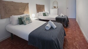A hotel room with two beds, a white dresser, a mirror, and a hanging light fixture. - Stay U-nique Apartments Casanova (Barcelona)