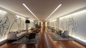 A modern hotel lobby with a central seating area, wooden flooring, and large wall art. - Gaia Residence (Vila Nova de Gaia)