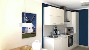 A modern kitchen with white cabinets, a built-in oven, and a coffee maker. - Baltic Sea Lodges, Deck 1, elevator, wellness area, close to the beach, family friendly (Niendorf)