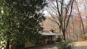A house with a brick exterior, a chimney, and a porch. - Winter mtn views 2 min. to center, fireplace: Monthly rentals welcome! (Columbus)