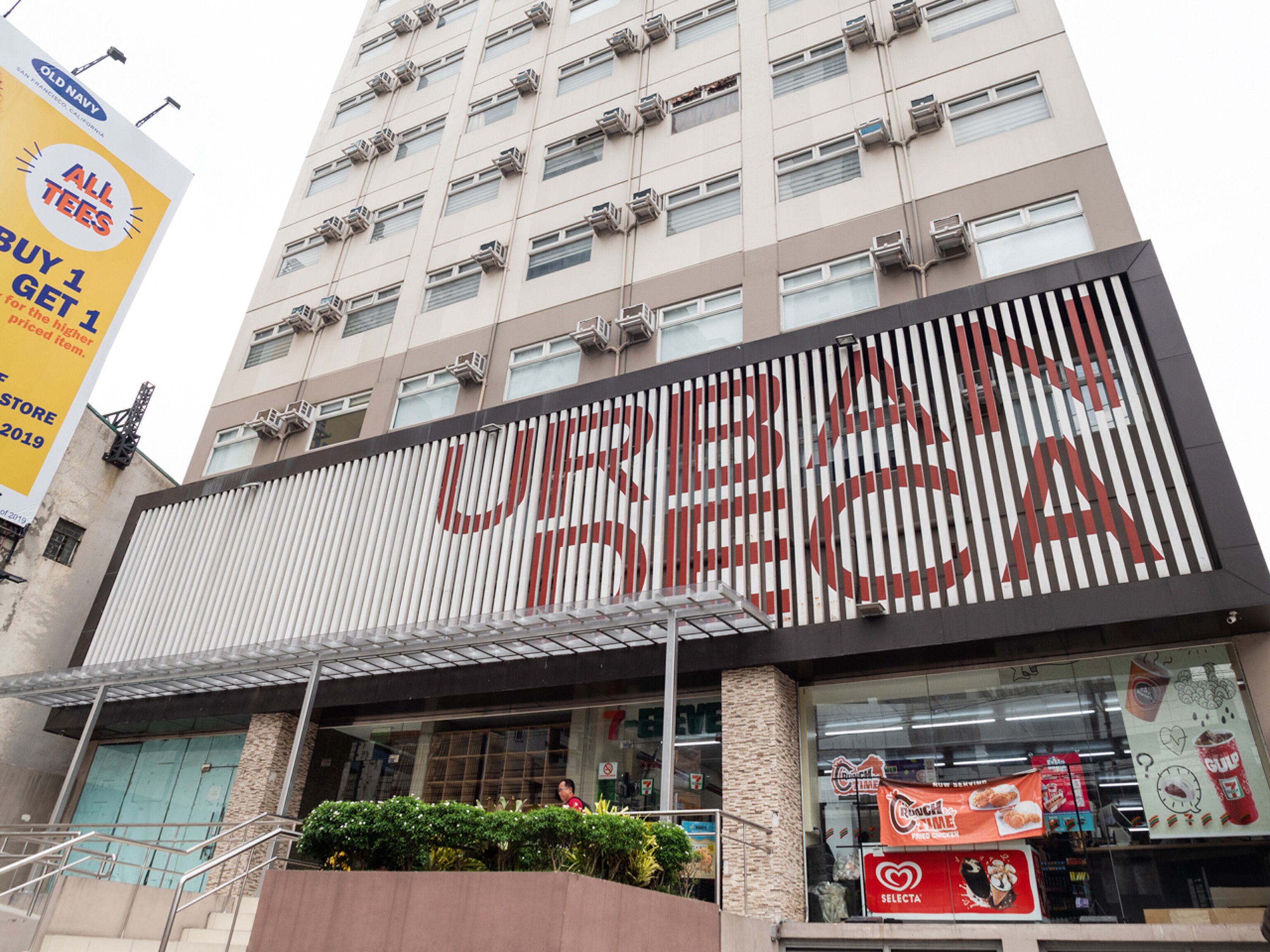 A building with a large sign reading "USECA" and a 7-Eleven store at the ground level.