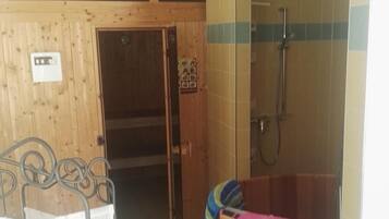 Relax in a serene space with a bathtub, shower, and comfortable bed.