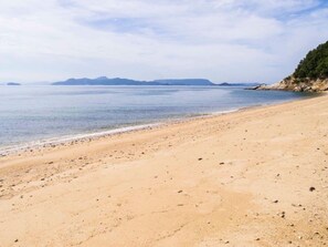 Enjoy a serene beach experience with fine sand and small pebbles.