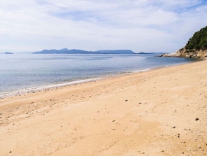 Enjoy a serene beach experience with fine sand and small pebbles.