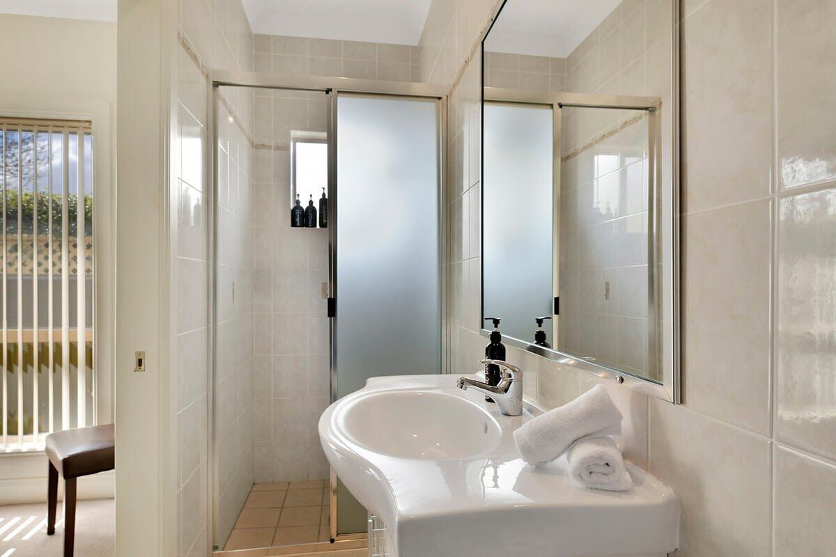 Bathtub, hair dryer, towels, shampoo