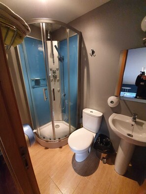 Chuveiro, toalhas de banho, sabonete, shampoo