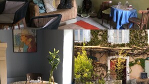 Un interior acogedor con una zona de comedor, un sofá y un cuadro.