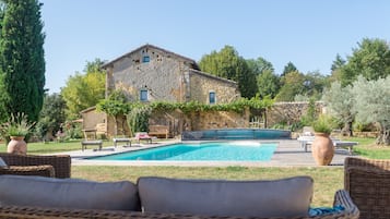 Een seizoensgebonden buitenzwembad en parasols bij het zwembad