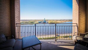 A balcony with a view of a river and a distant structure. - Water Street Retreat 08 (Wilmington)