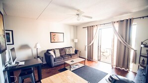 A modern living room with a desk, sofa, and a ceiling fan. - Water St. Retreats 03 Historic riverfront paradise (Wilmington)