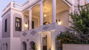 A building with a classical architectural style, featuring columns, arches, and a balcony.