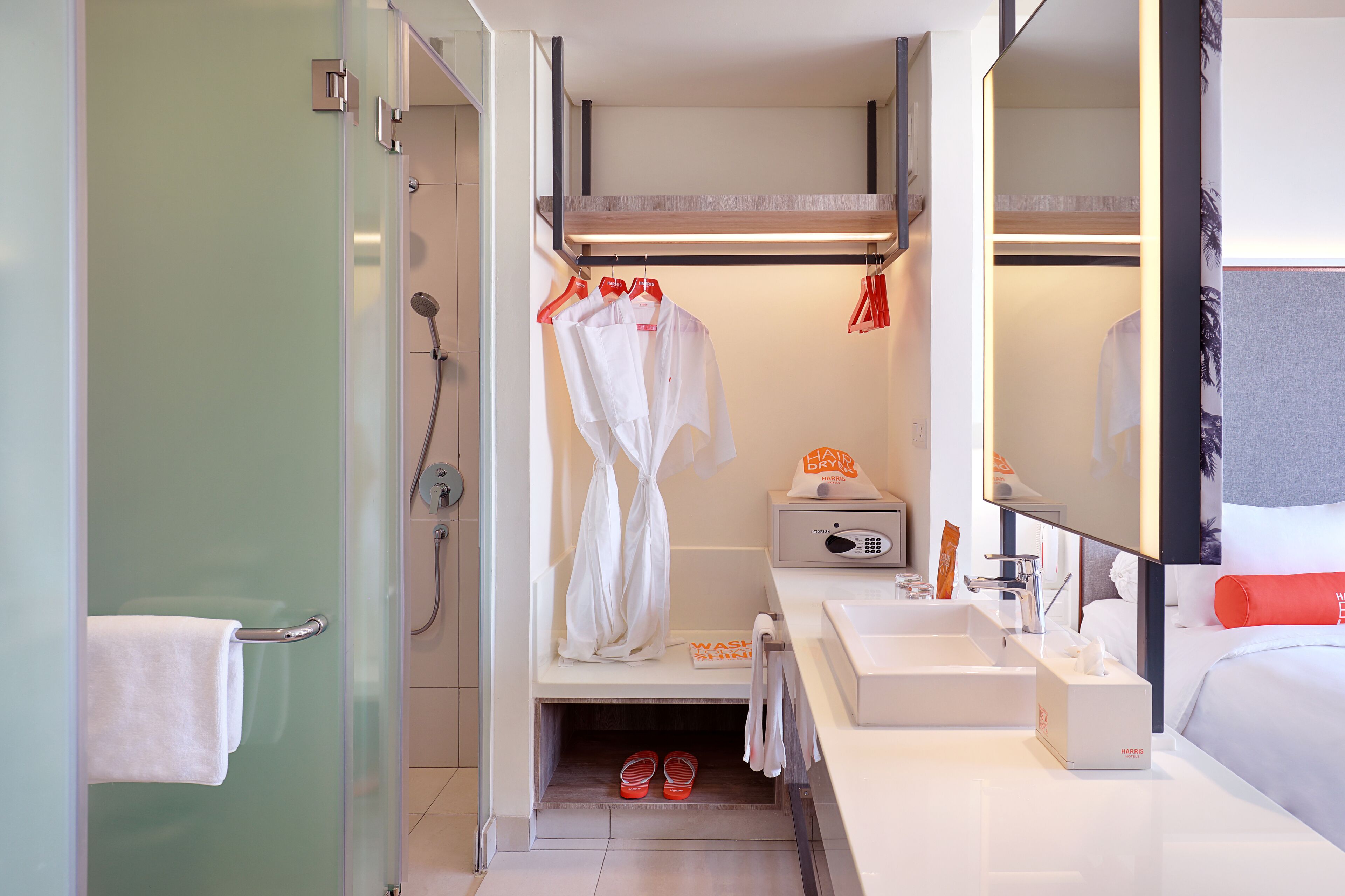 A modern bathroom with a shower, a sink, and a mirror.
