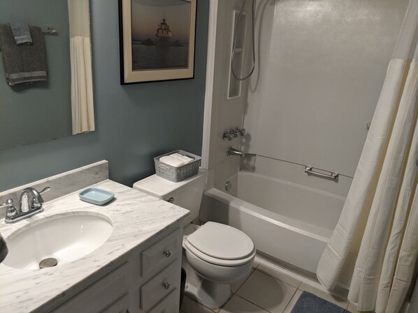 A bathroom with a sink, toilet, and bathtub.