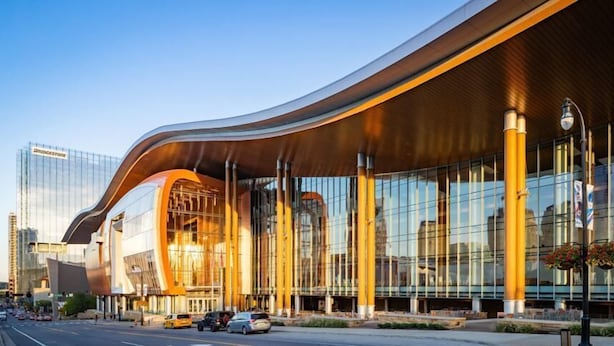 A modern building with a curved roof and large glass windows.