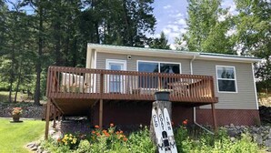 A two-story cabin with a wooden deck and a small porch. - Old Goat Inn, Wonderful Cottage on Flathead Lake (Somers)