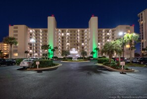 Stunning hotel entrance with a central entrance flanked by palm trees and beautifully maintained gardens.