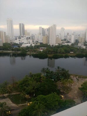 A high-rise building complex with a body of water in the foreground. - Disfruta de la belleza de cartagena (Cartagena)