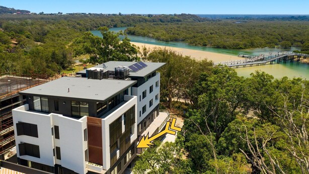 A modern building with a flat roof, large windows, and a view of a river and forest. - Nineteen On Gregory G02 - Slow M'Ocean - Linen Supplied (SOUTH WEST ROCKS)