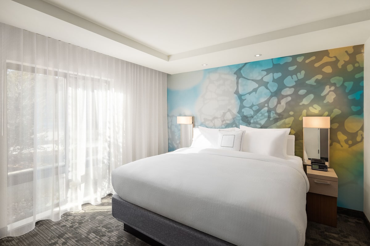 Premium bedding, desk, laptop workspace, blackout drapes