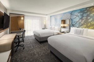 Premium bedding, desk, laptop workspace, blackout drapes