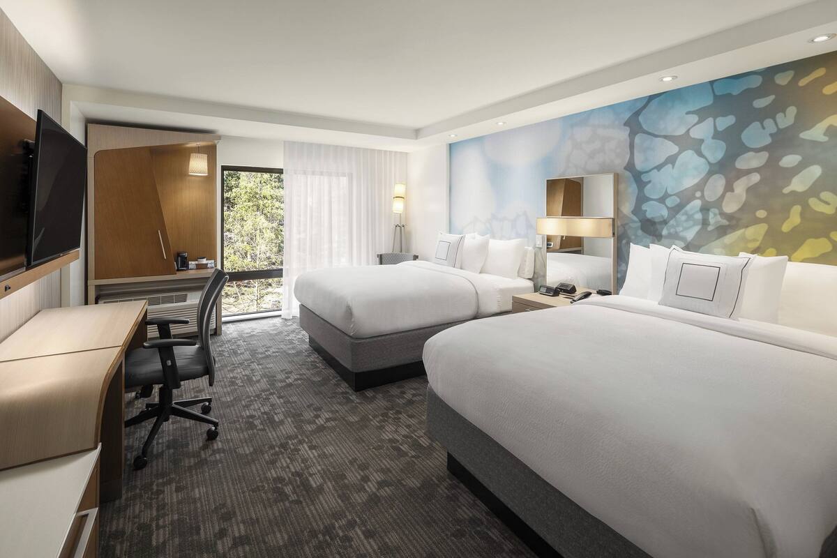 Premium bedding, desk, laptop workspace, blackout drapes