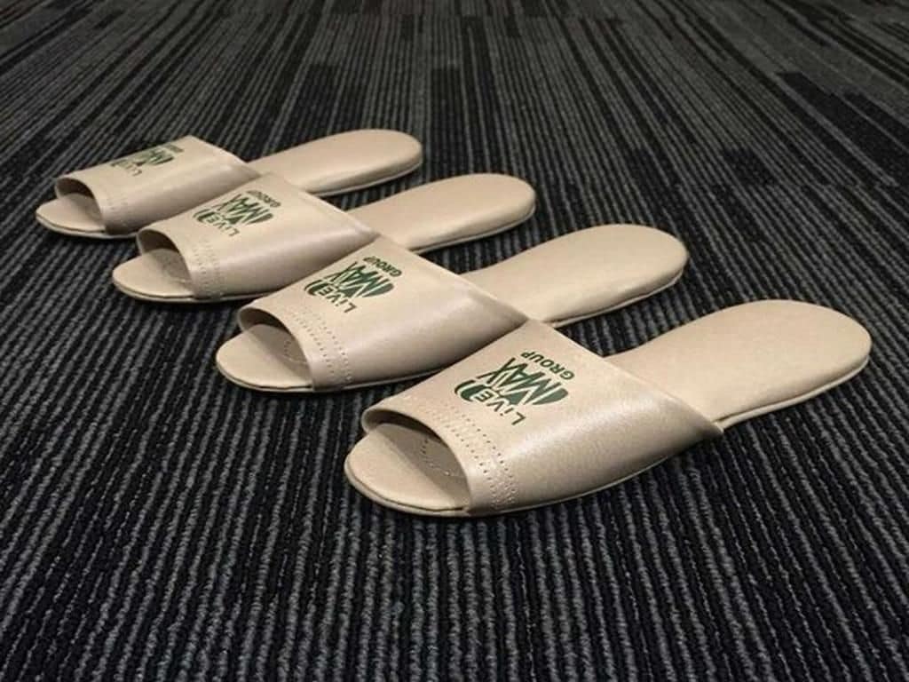 Four beige slides with 'LIVE' and 'GROUP' text on a textured carpet.