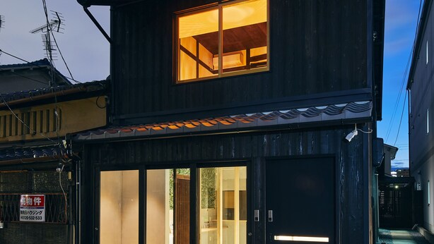 A two-story building with a large window on the upper floor and a ground-floor entrance. - Seven Stay Ouchi (Kyoto)