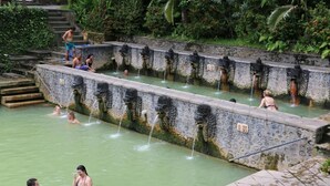 A traditional stone water feature with multiple fountains, surrounded by lush greenery. - Shanti Natural Panorama View Hotel (Sukasada)