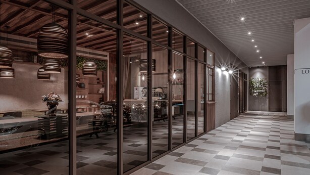 A modern hotel corridor with checkered flooring, glass walls, and wooden ceiling panels. - Somer Chew Hotel (Tainan)