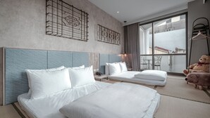A hotel room with two beds, a large window with a view, and a teddy bear on the right side. - Somer Chew Hotel (Tainan)